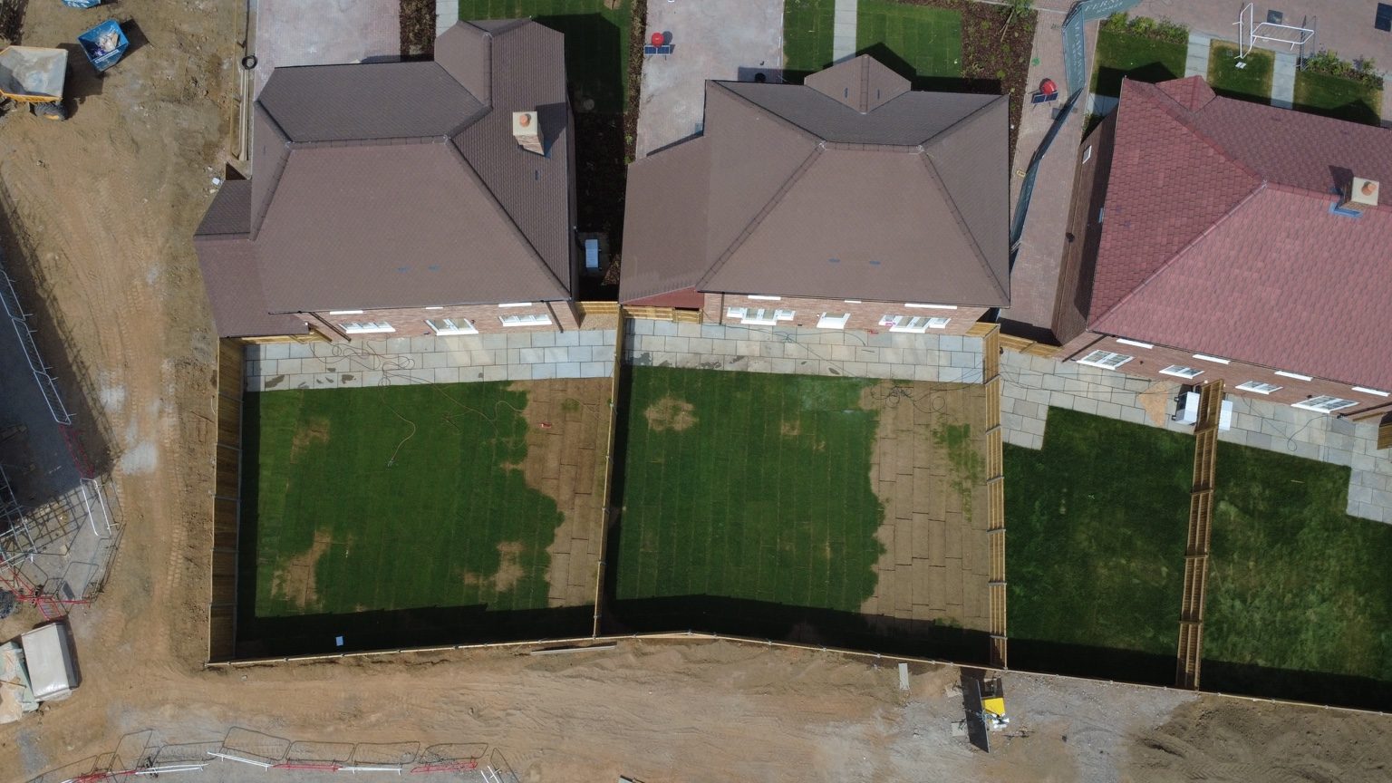Overhead drone photograph of new-build homes and rear gardens